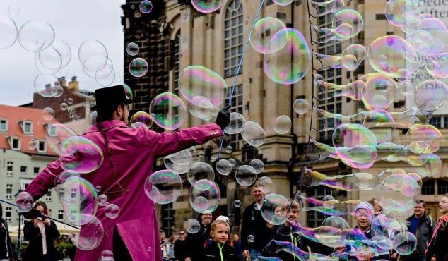 A street artist creating giant soap bubbles in Dresden, Germany.