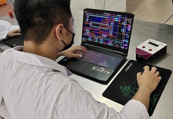 Research team member designing the microcontroller part of the device