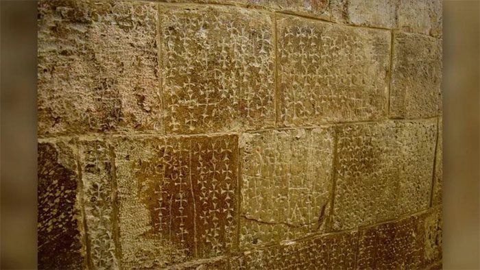 The crosses on the wall at the Church of the Holy Sepulchre in the Holy Land of Jerusalem.