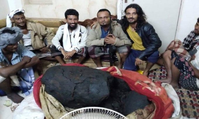 Fishermen posing next to the ambergris.