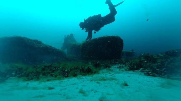 An archaeologist excavating artifacts from the lake bed