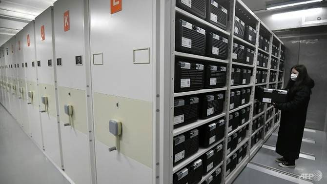 A researcher examining the 'black box' containing seeds in the storage room.