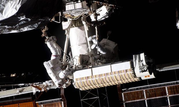 Astronauts conducting a spacewalk to replace solar panels for the space station.
