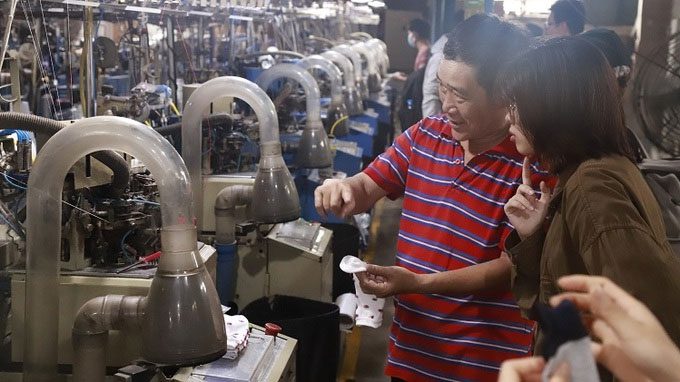 The Re.socks team visits the factory to learn about the sock knitting process.