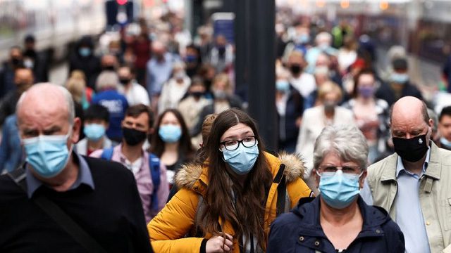 People in England wearing masks to combat the pandemic.