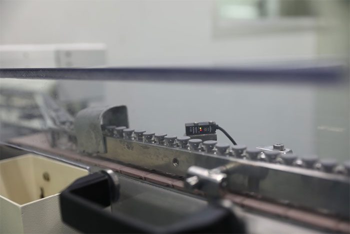 Then, the machine will proceed to seal the vials with rubber caps to ensure vaccine safety.