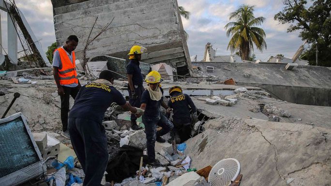 Firefighters searching for survivors in Les Cayes.