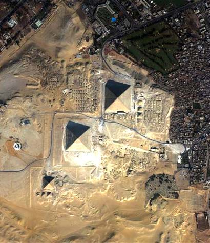 The Egyptian pyramids rise from the desert like four-faced gems.