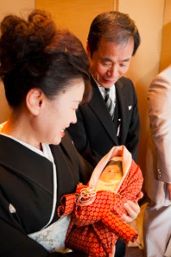 Rice baby sent to relatives so they can hold it like a real newborn.