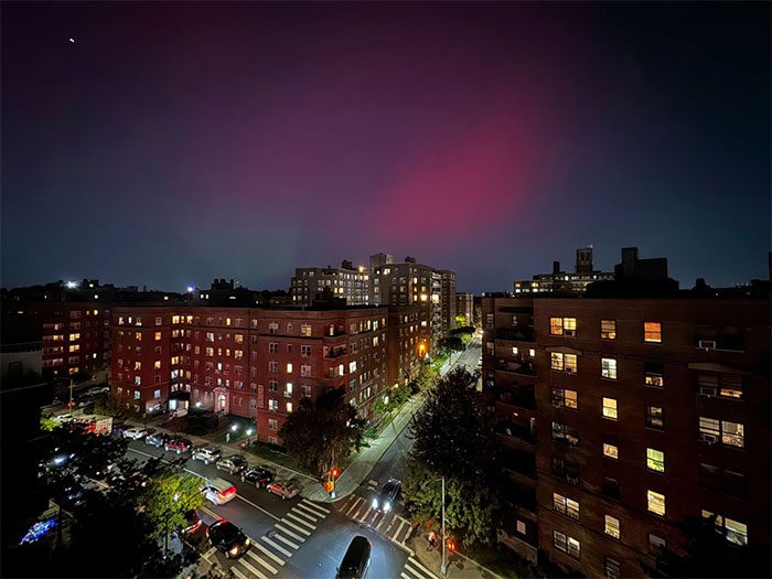 Brilliant aurora over the night sky above apartment buildings in Queens, New York, USA, on October 10.