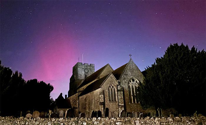 Aurora illuminating the sky above Great Chart Church in Ashford, England, on October 10.