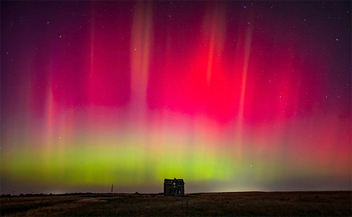 Brilliant aurora over an abandoned house near Marquette, Michigan, USA.