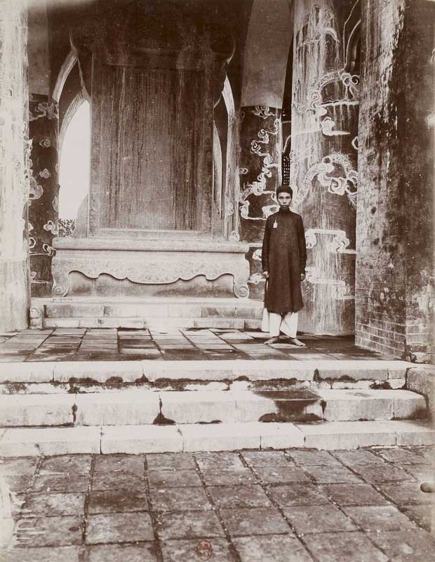 A man stands in front of the tomb of Emperor Tự Đức.