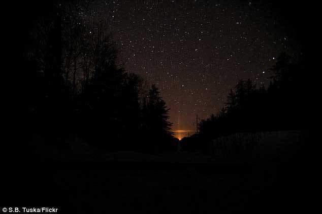 The mysterious light originates from vehicles traveling on the nearby highway.