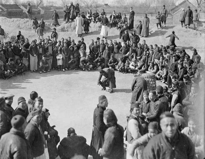 People gathering to watch cockfighting, in Kaifeng, Hebei Province.