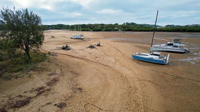 Boats stranded at Bucasia after the tide receded.