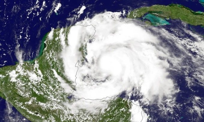 Category 1 hurricane Ernesto causes flash flooding and widespread power outages in Puerto Rico.