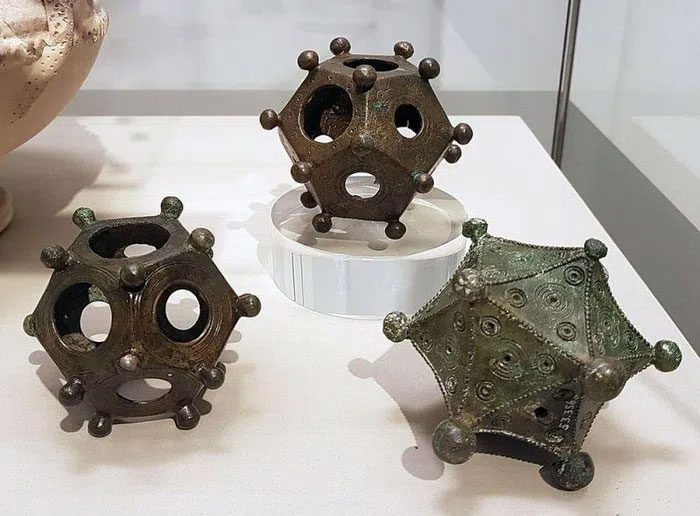 Dodecahedrons with various designs and sizes.