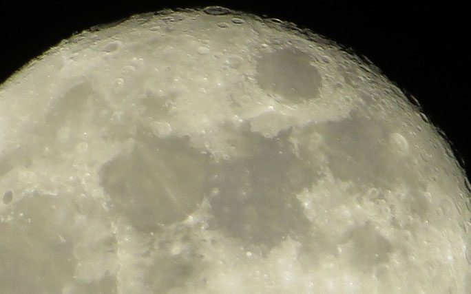 The surface of Earth's Moon is quite rugged, covered with craters