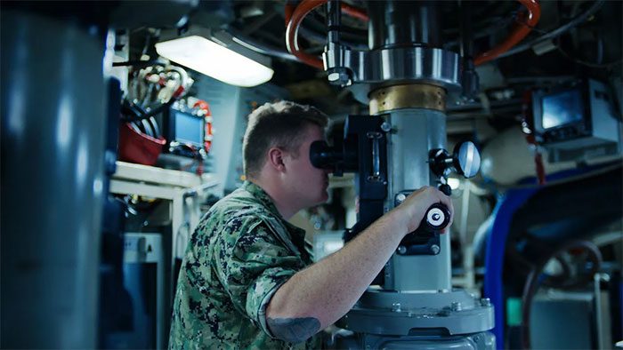 A crew member working inside a submarine.