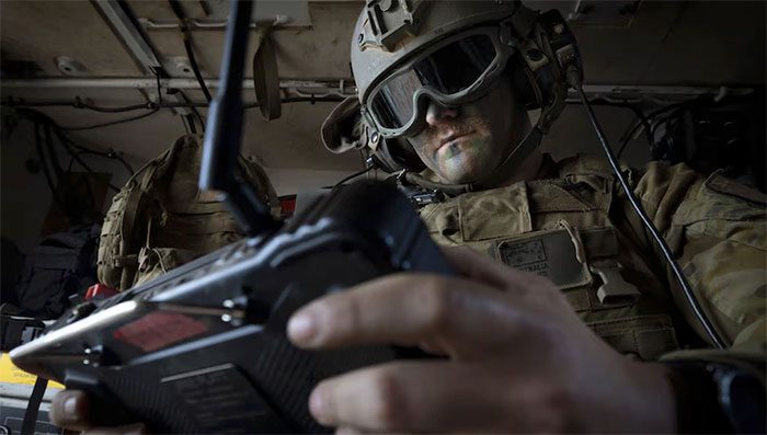 A soldier remotely operating a weapon system