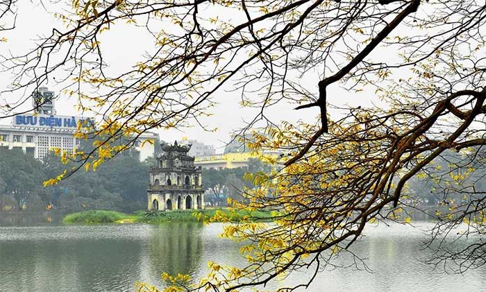 Visiting the Shore of Hoan Kiem Lake as a cultural habit in Hanoi.