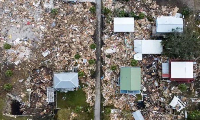 Debris surrounding intact homes after Hurricane Helena hit the beach