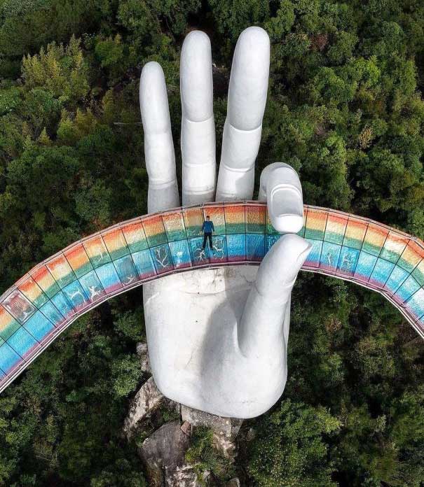 The Rainbow Hand Bridge features a hand holding a rainbow walkway.