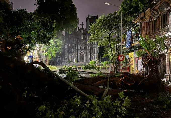 . In front of St. Joseph's Cathedral in Hanoi, two large trees fell across the street.