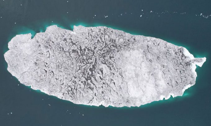 Mesyatsev Island, which is essentially an iceberg that separated from Eva-Liv Island, floating on the sea.