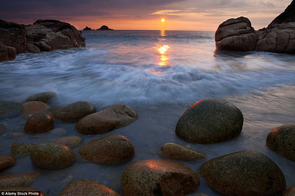 The giant boulders resembling dinosaur eggs are located at Porth Nanven Beach, Cornwall, England.