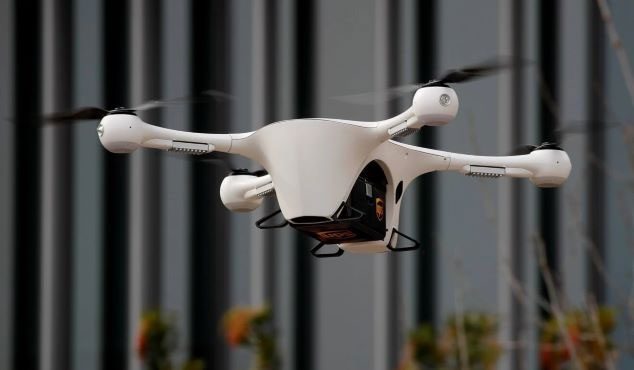 The bubble gun filled with pollen attached to a drone.