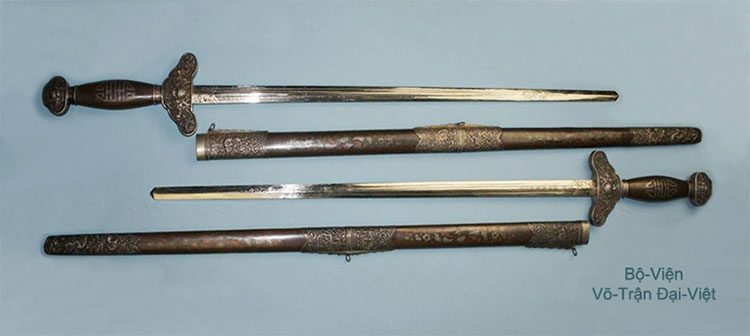 Two shiny swords with matching scabbards from the Đại Việt period.