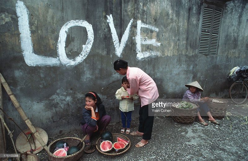 A wall with the word "Love" in an alley.