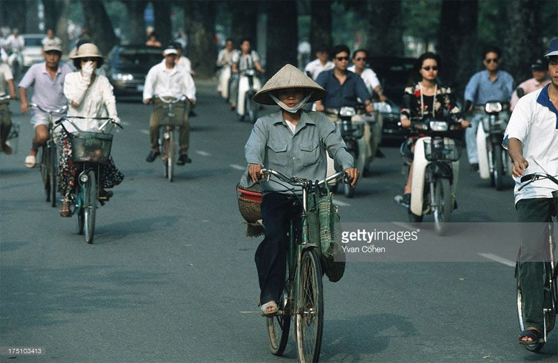 Bicycles and motorbikes sharing the road.