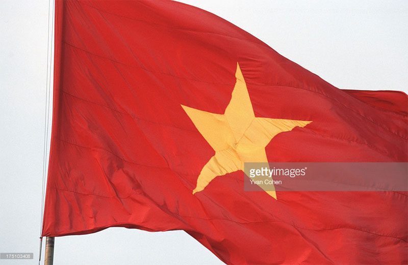 The national flag of Vietnam flying at Ba Dinh Square.