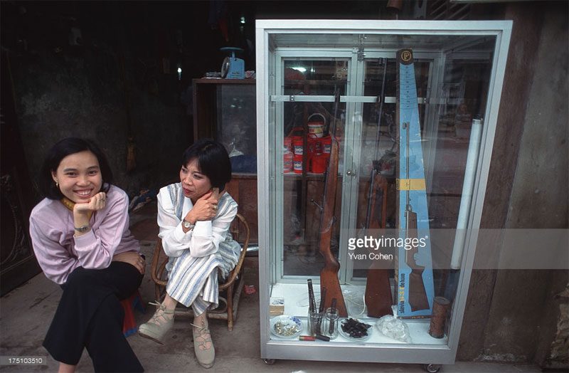 Two women at an air gun shop.