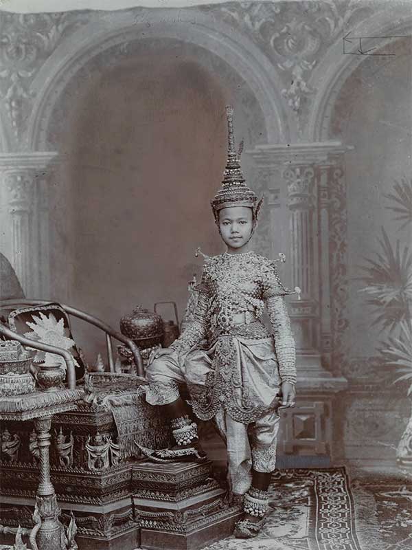 A young prince of Siam dressed in traditional attire embedded with jewels.