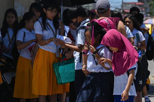 Students in Manila during a severe heat wave that forced classes to be canceled.