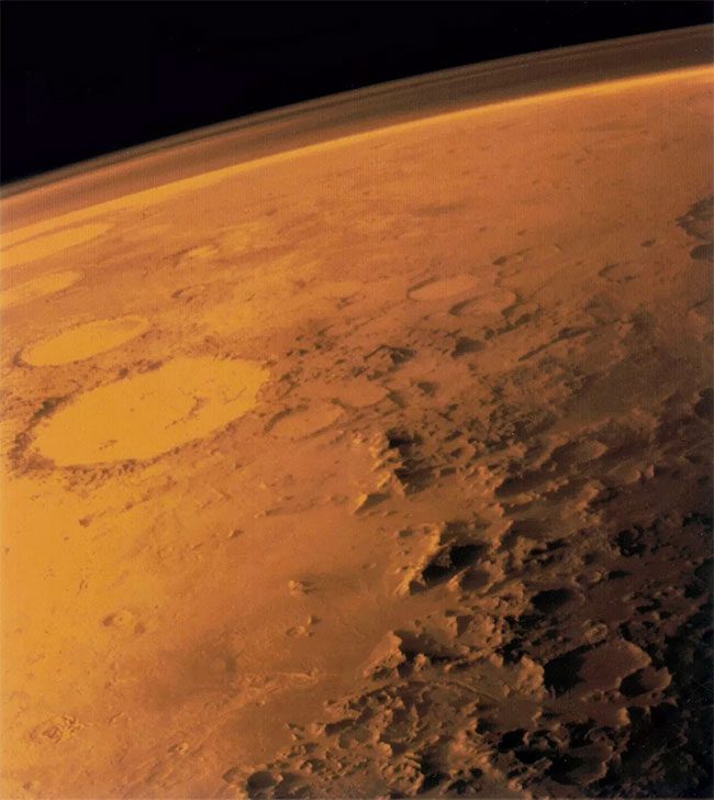 The thin atmosphere of Mars, viewed from the horizon in a low-orbit photo.