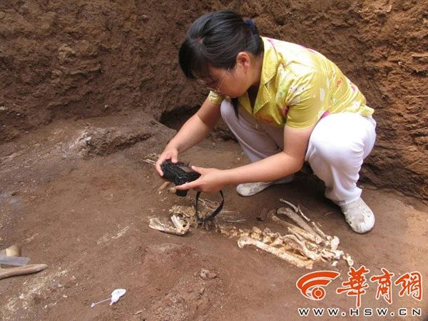 An archaeologist working in the excavation area.