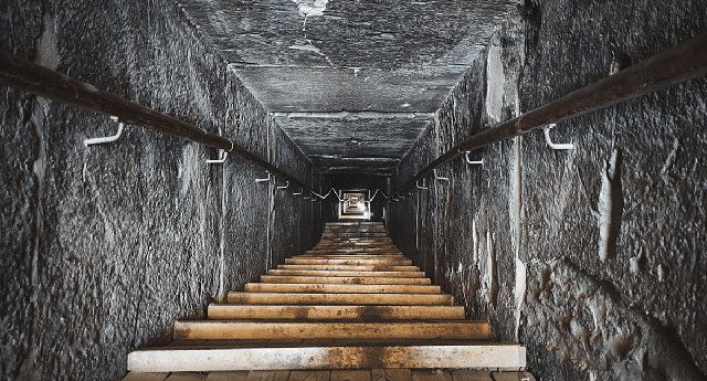 The entrance to the pyramid is sealed by a large stone.