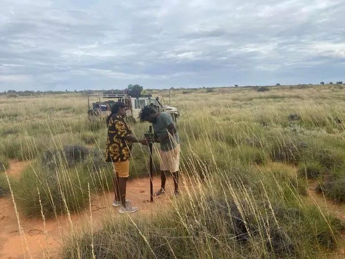 Research team setting up audio recorders and camera traps