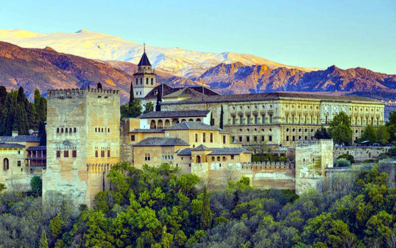 Alhambra Castle in Spain, featuring interconnected architecture with beautiful gardens.