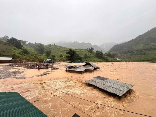 Floodwaters reaching the roofs of houses in Yen Bai.