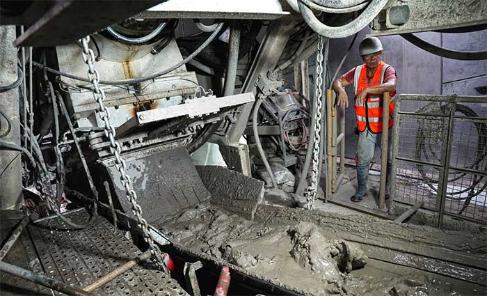 At the drill head, excavated soil is transported outside via a conveyor belt.