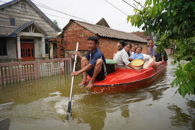 Residents of Soc Son struggle as floodwaters inundate their yard by about 2 meters.