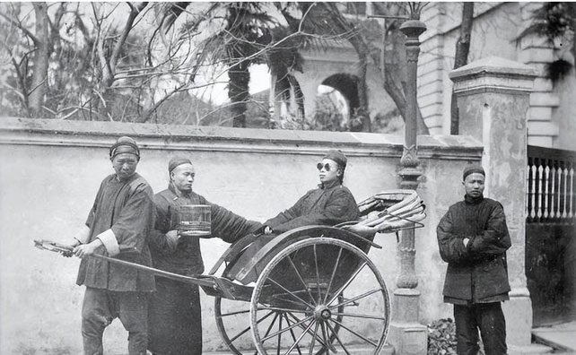 A young nobleman stepping out of the door with a servant holding a birdcage.