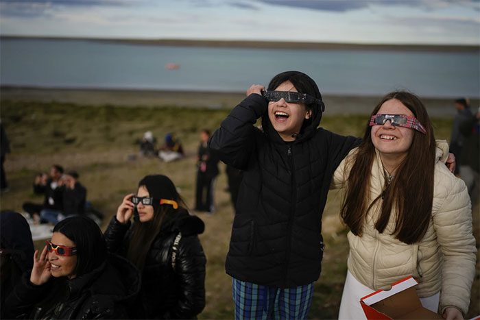 Children and adults alike excitedly watching the solar eclipse.