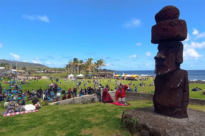 Locals and tourists gather to witness the annular solar eclipse at Isla de Pascua